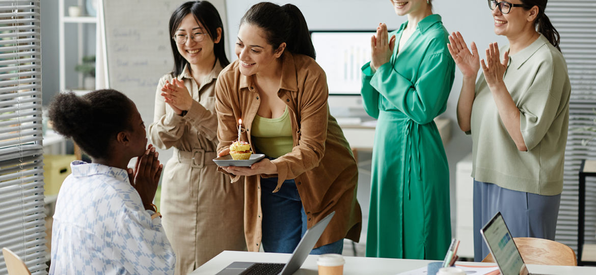 Businesswomen congratulating their colleague at office